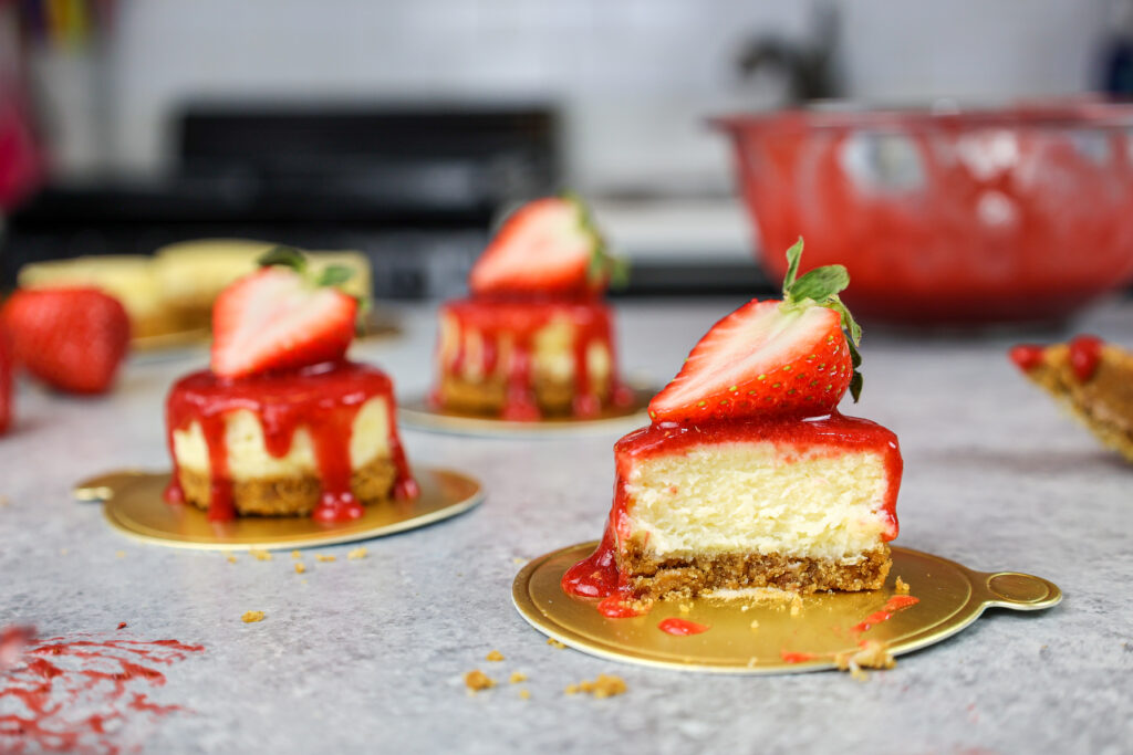 image of a mini strawberry cheesecake that's been cut into to show how creamy and fluffy it is