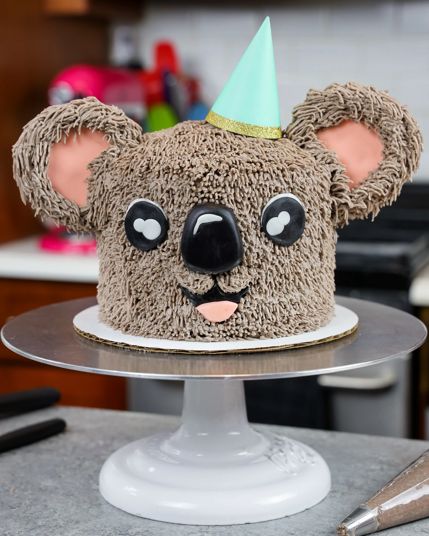 image of an adorable buttercream koala cake made with chocolate cake layers