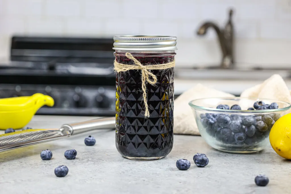 image of blueberry simply syrup poured into a mason jar for storage