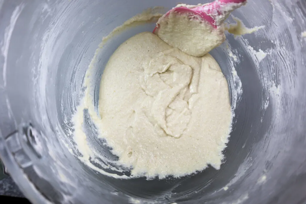 image of white vanilla macaron batter that's been used to draw a couple figure 8's  indicating it has been mixed perfectly and is ready to be piped