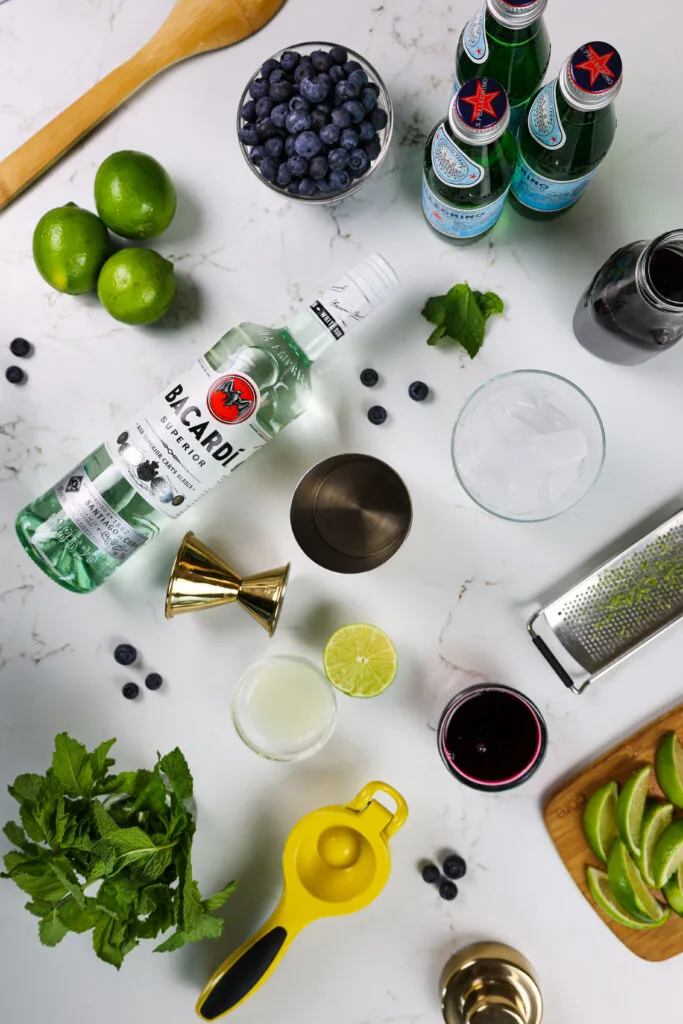 image of ingredients laid out on a counter to make blueberry mojitos
