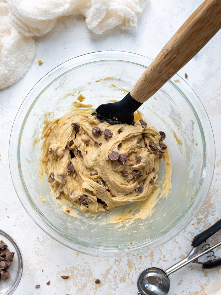 image of no chill chocolate chip cookie dough that's been mixed in glass bowl