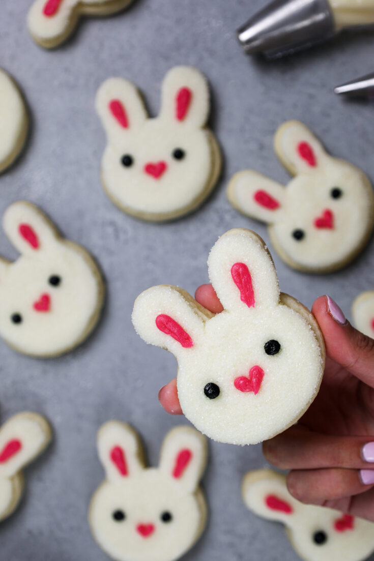 image of a rabbit cookie frosted with buttercream frosting to look just like a bunny rabbit's face