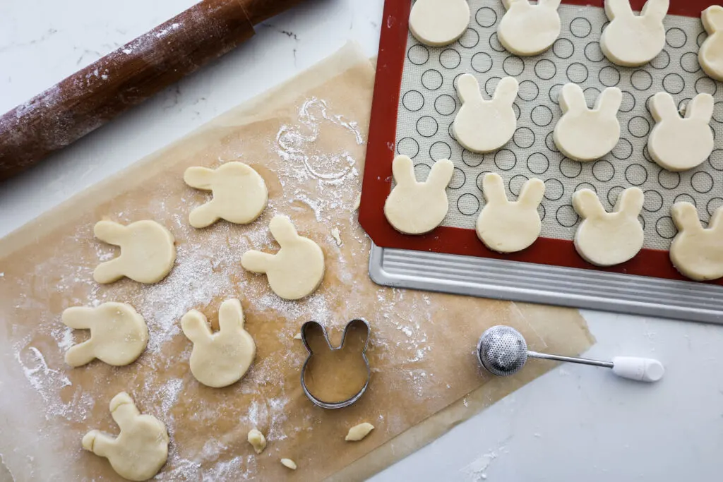 image of cute easter bunny cookies being cut out and ready to be baked