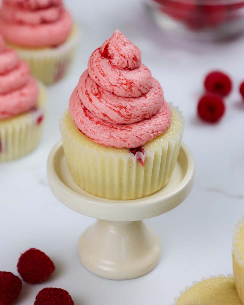 image of raspberry cupcakes made with vanilla cupcakes and raspberry buttercream