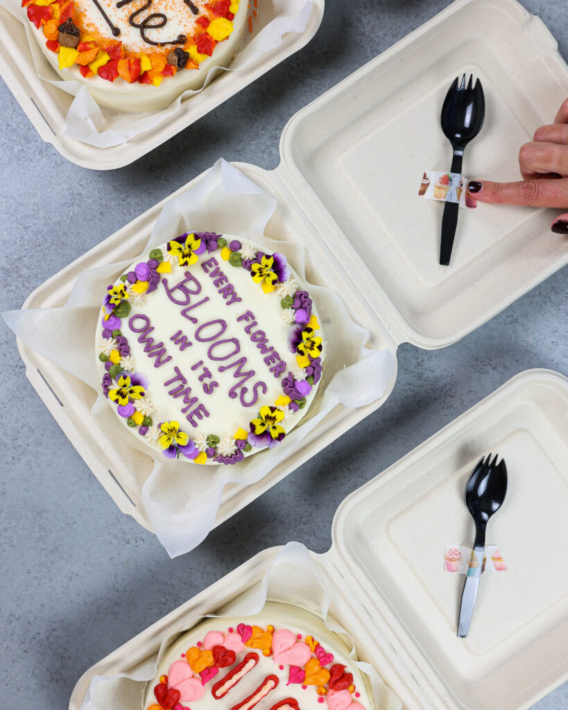 image of an cute bento cake or lunch box cake decorated with a cute saying and edible flowers