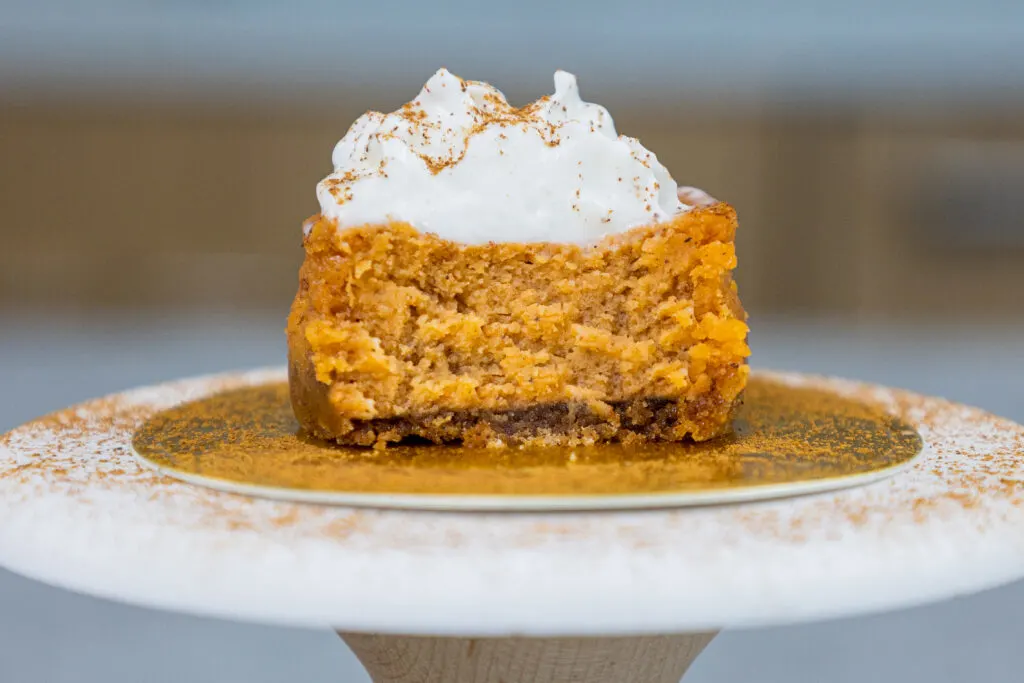image of a pumpkin cheesecake cupcake that's been cut open to show it's cream inside