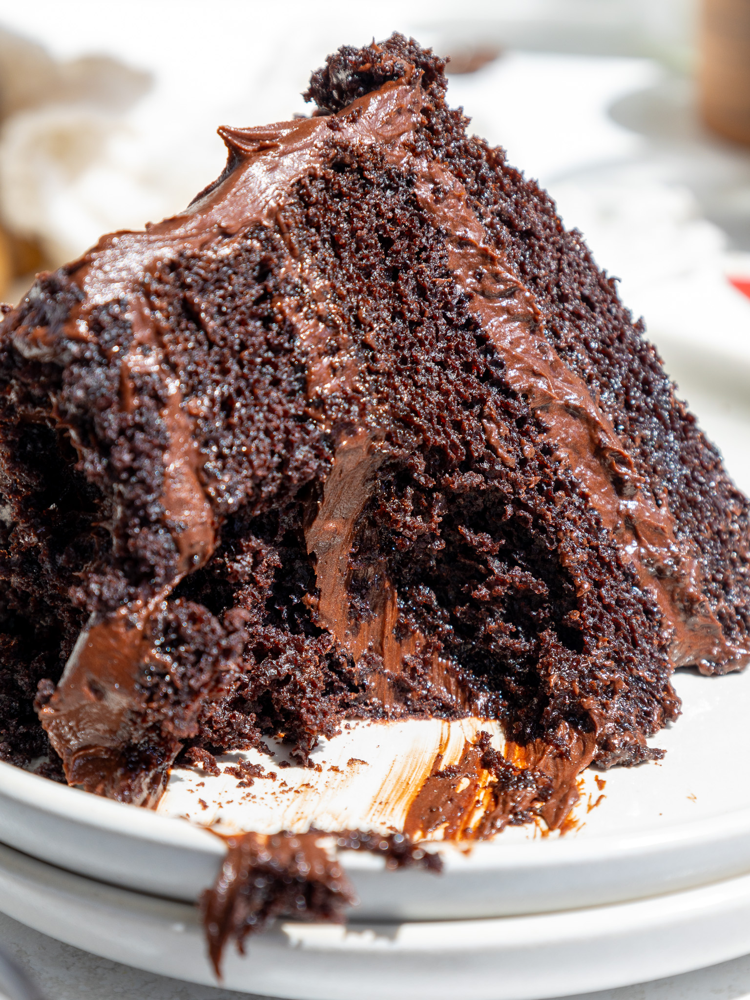 image of a slice of death by chocolate cake that's been cut into to show how moist it is