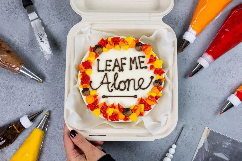 image of a cute bento cake decorated for Fall that says leaf me alone on top