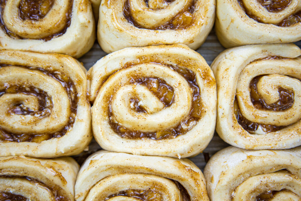 image of caramel apple cinnamon rolls that have been proofed and are ready to be baked