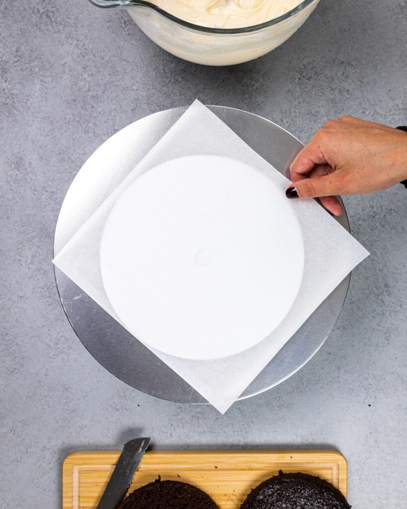 image of a parchment square being placed on a spinning cake stand