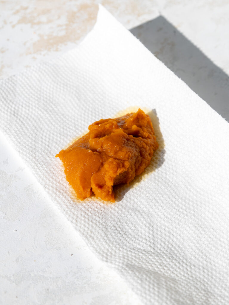 image of pumpkin puree that's been scooped onto a piece of paper towels