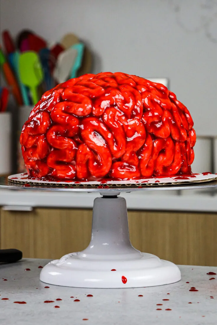 image of a bloody brain cake made for halloween with red velvet cake layers and raspberry jam blood
