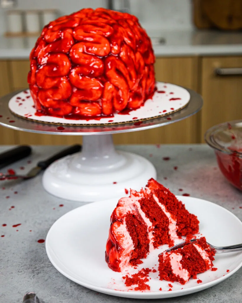 image of a slice of red velvet cake on a plate that's been cut from a brain
