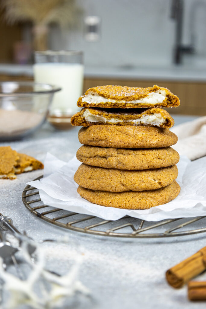 image of pumpkin cheesecake filled cookies stacked on top of one another