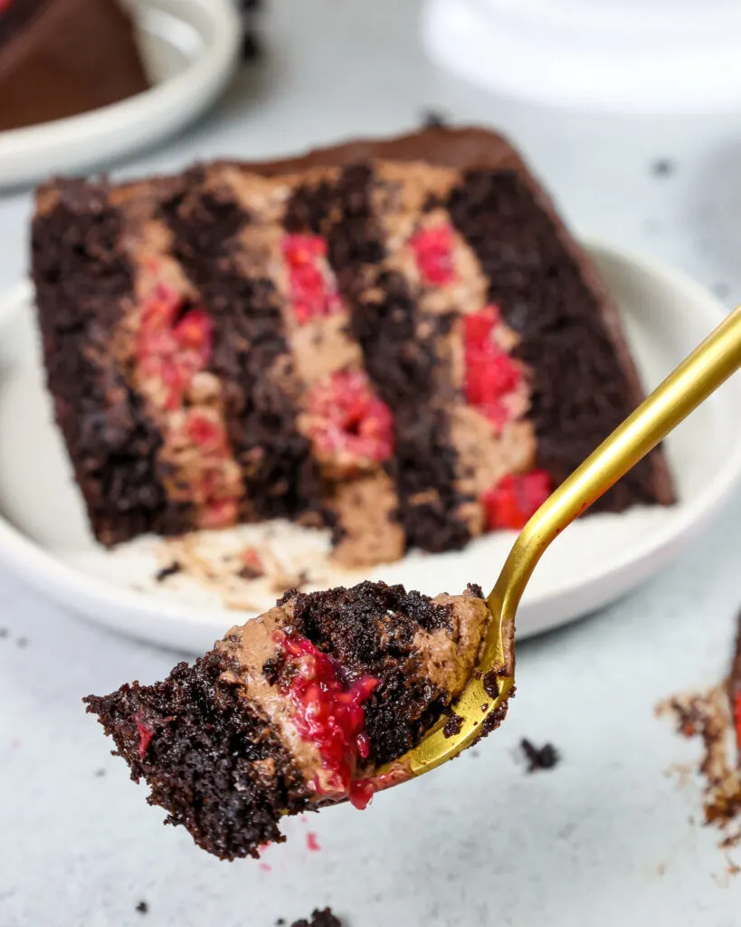 image of a bite of chocolate raspberry mousse cake on a fork