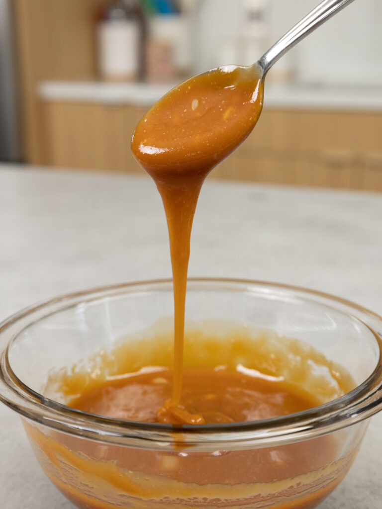 image of caramel sauce that's been made and is cooling in a glass bowl
