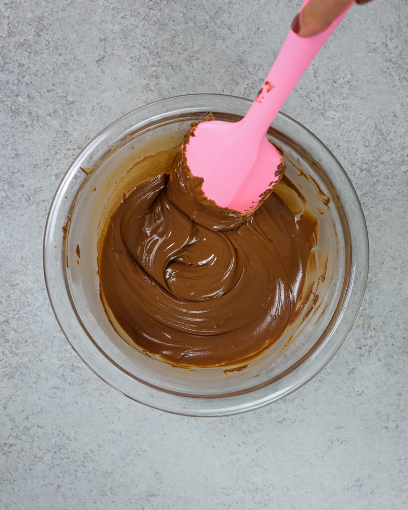 image of dark chocolate that's been melted to make chocolate mousse cake filling 