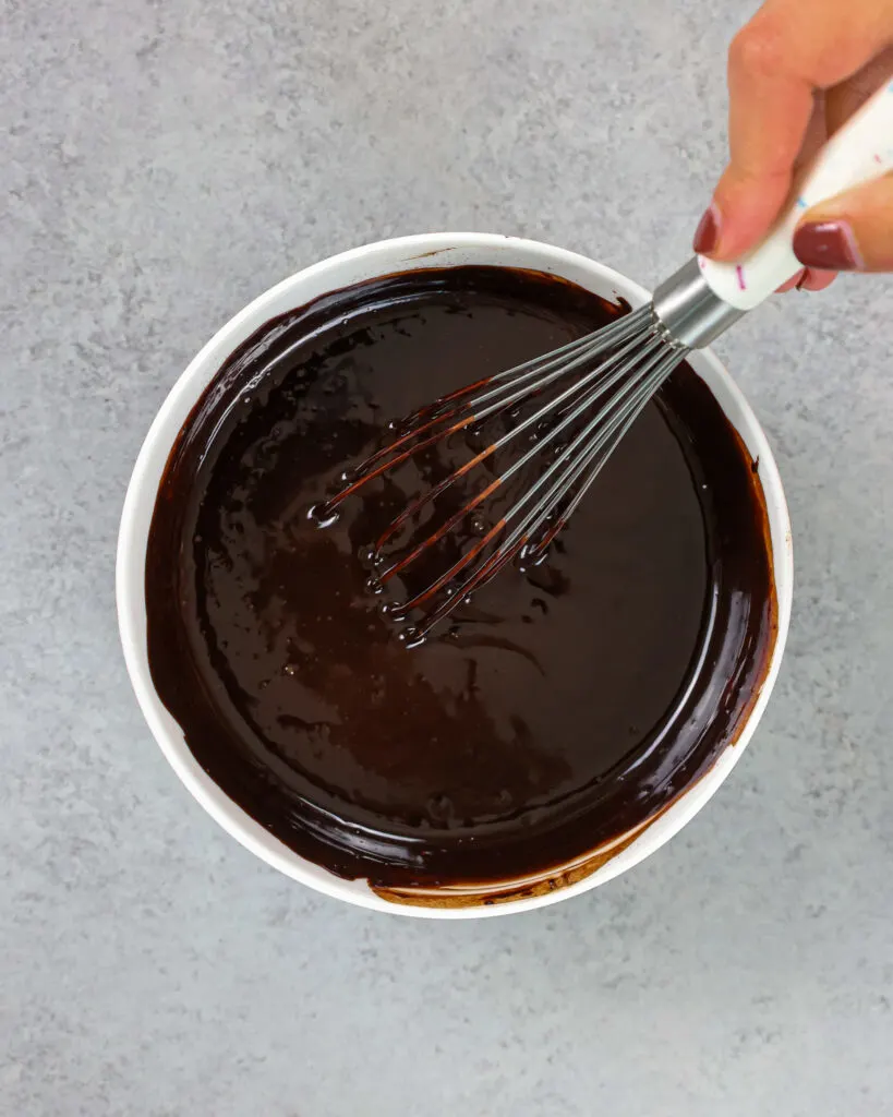 image of water, cocoa powder and dark chocolate that have been whisked together