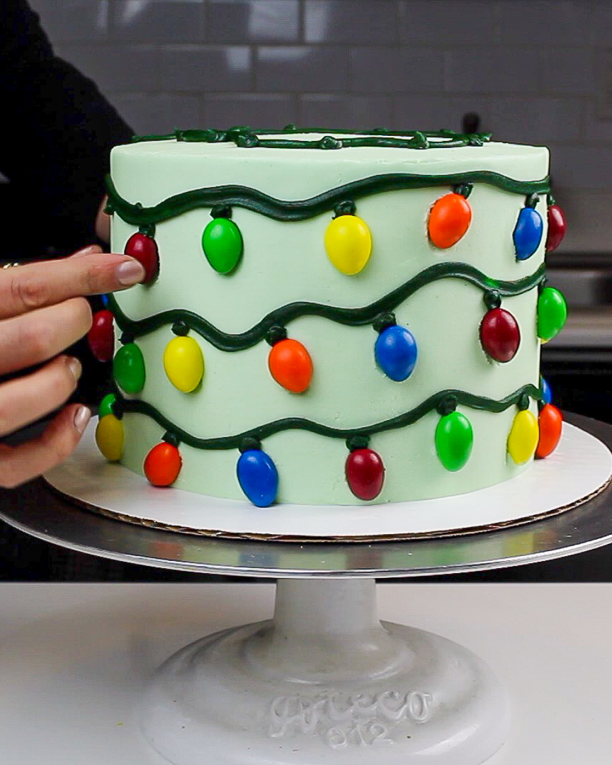 image of a christmas lights cake decorated with almond m & ms to look just like christmas lights