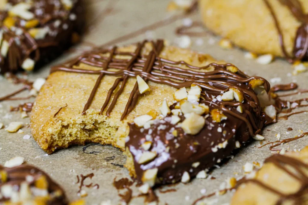 an image of chocolate dipped peanut butter cookies with a bite take out