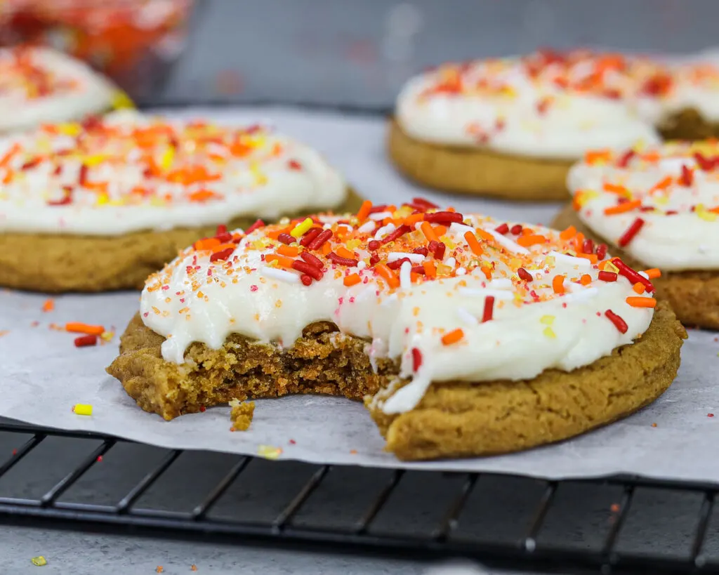 image of a frosted gingerbread cookie topped with buttercream frosting and festive fall sprinkles