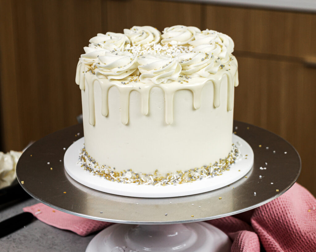 image of a white drip cake made with white chocolate ganache drips