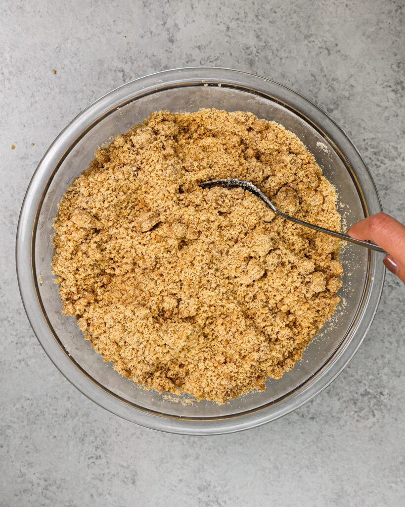 image of cinnamon streusel topping being made with a fork