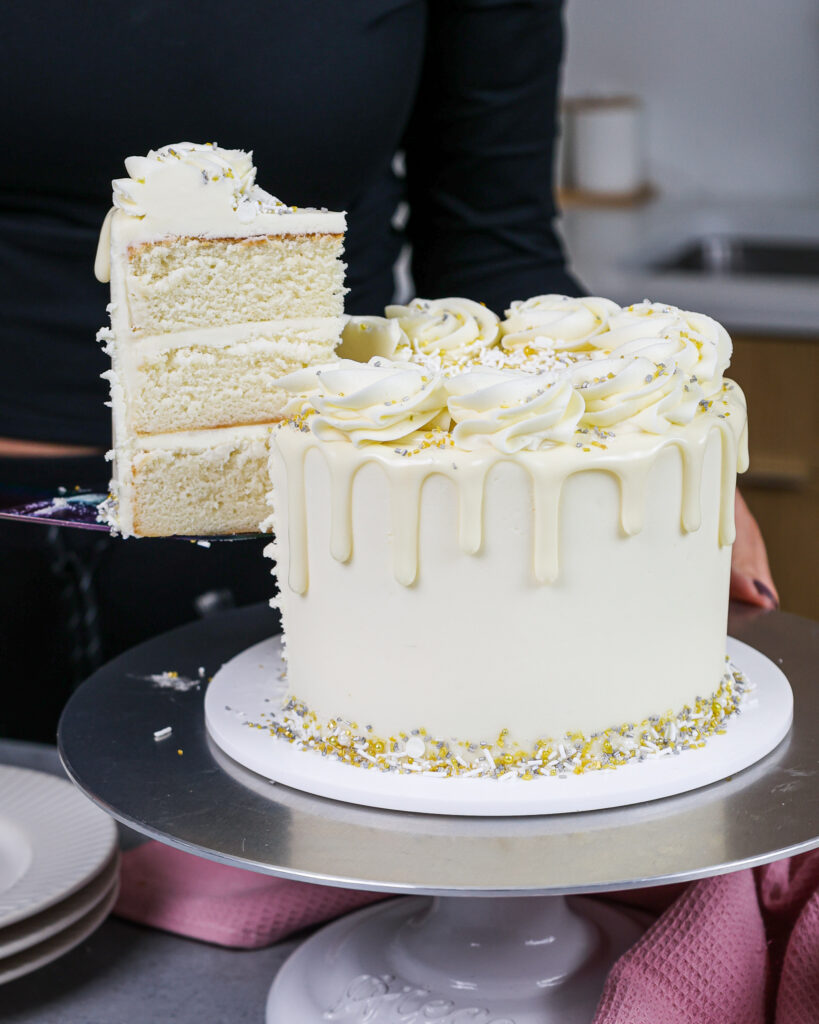 image a slice of cake being cut from a 6-inch layer cake made using a small batch cake recipe
