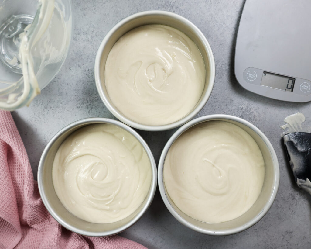 image of vanilla cake batter that's been poured into 6-inch cake pans and is ready to be baked