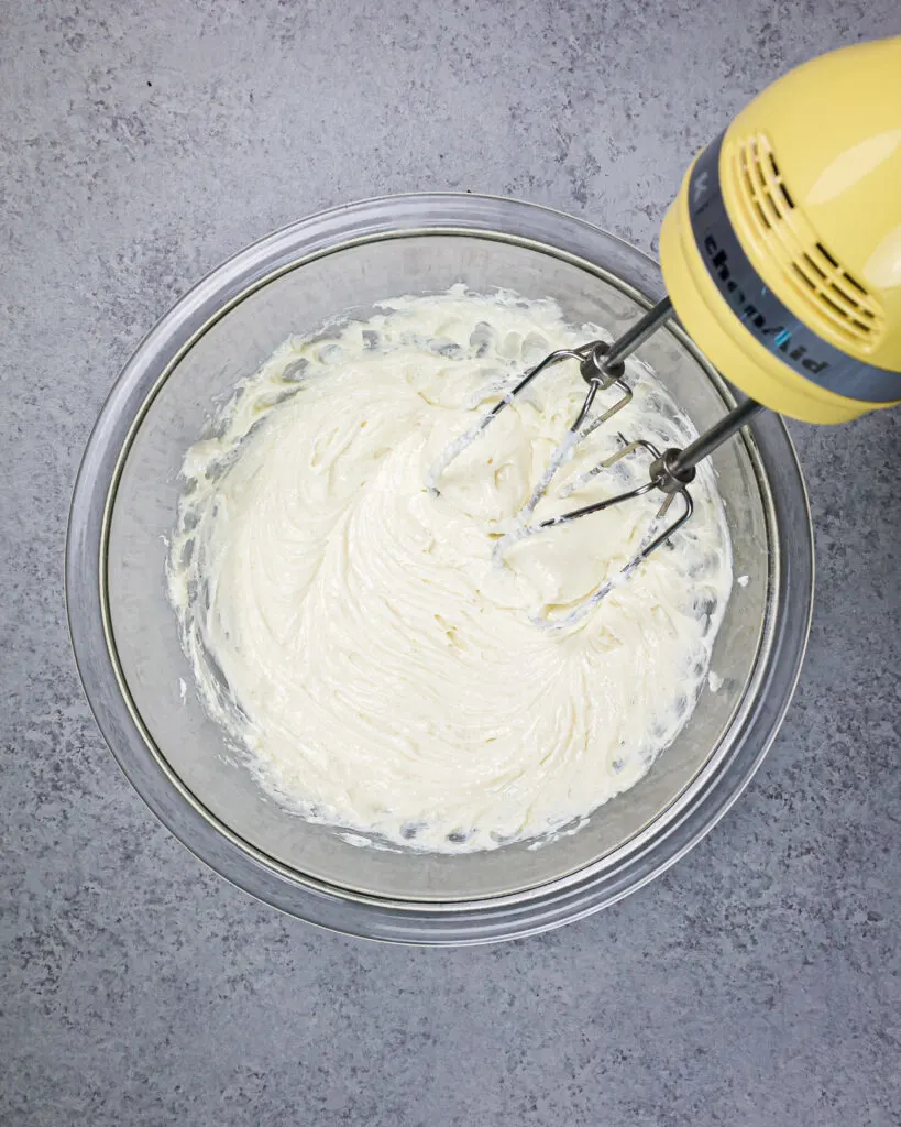 image of cheesecake filling being mixed with a hand mixer