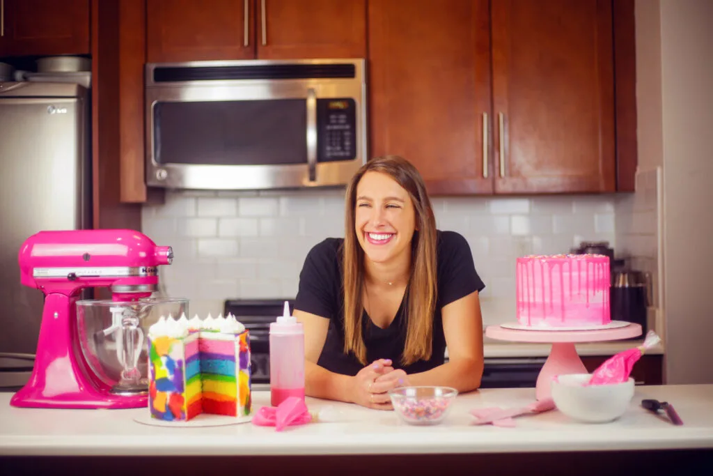 image of chelsey white, the founder of chelsweets, in her original kitchen making cakes for her blog and social media