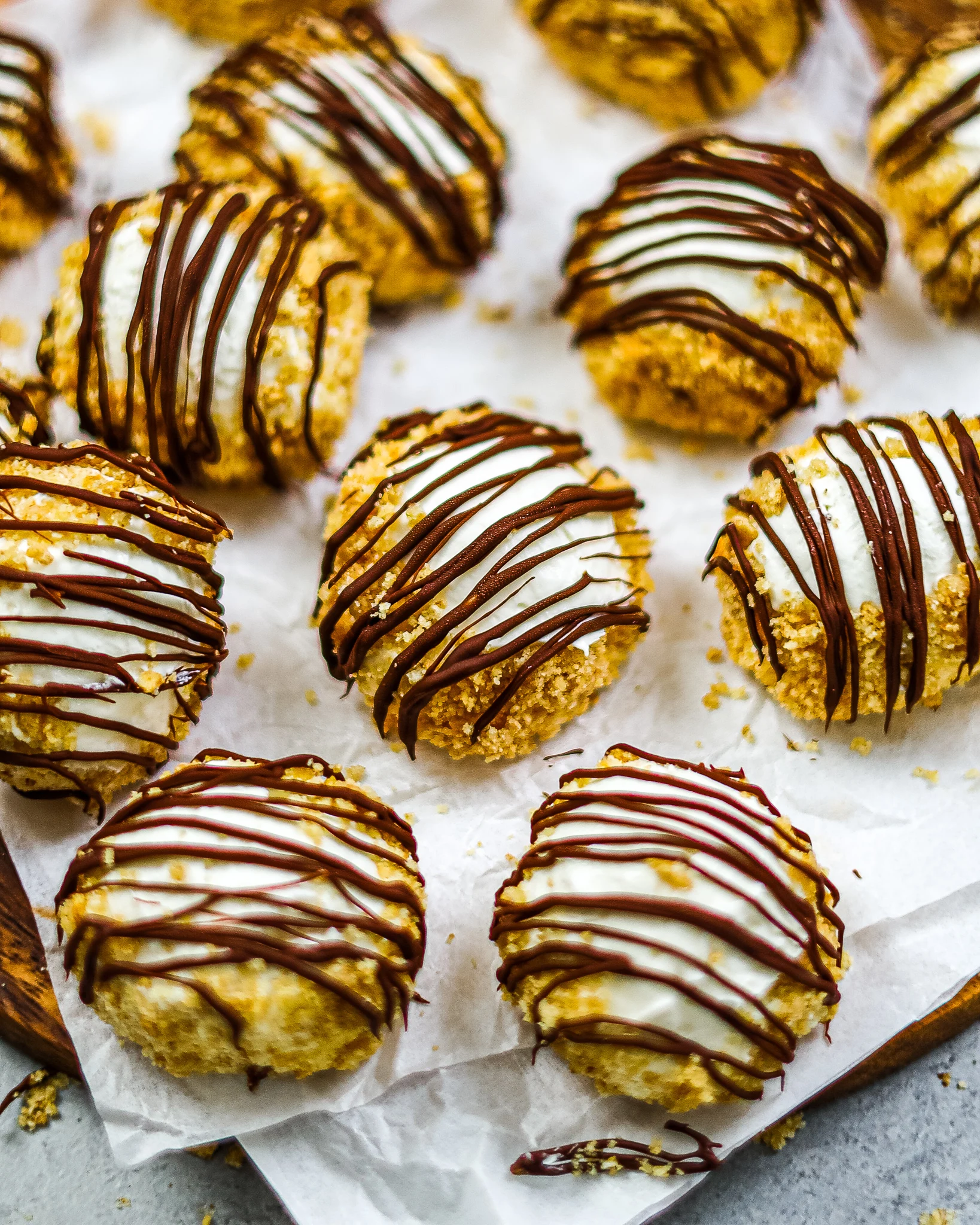 image of no bake cheesecake bites that have been drizzled with melted chocolate
