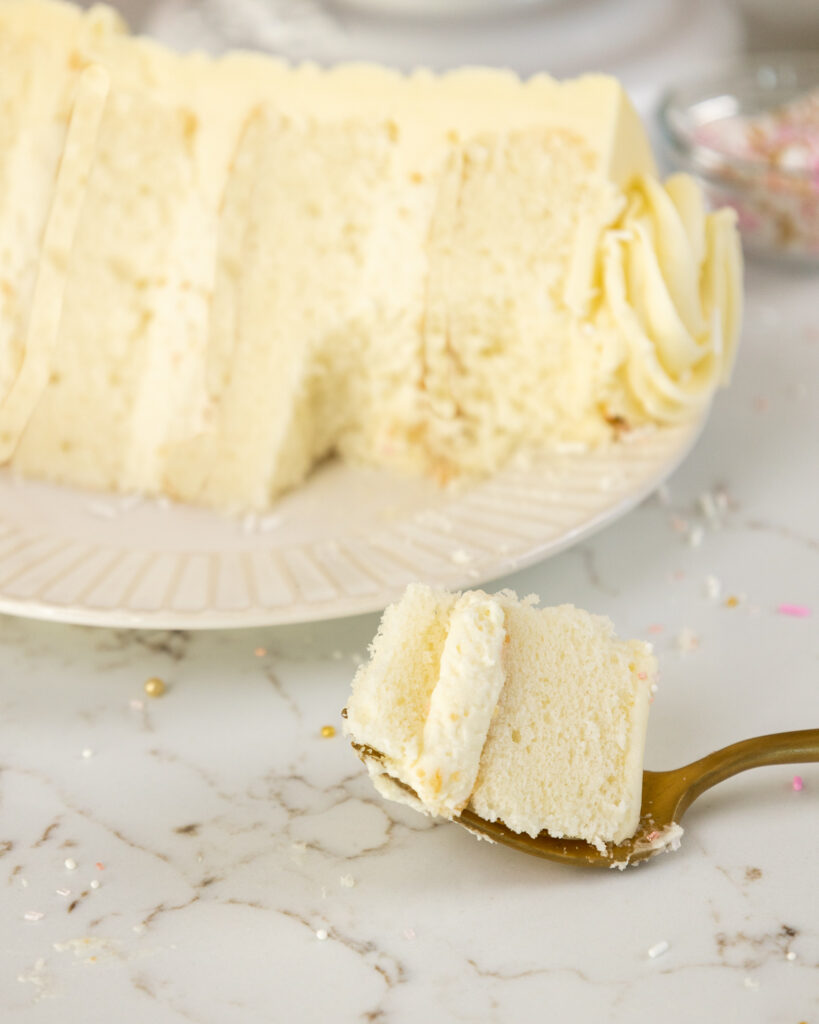 image of a bite of white chocolate mousse cake on a fork