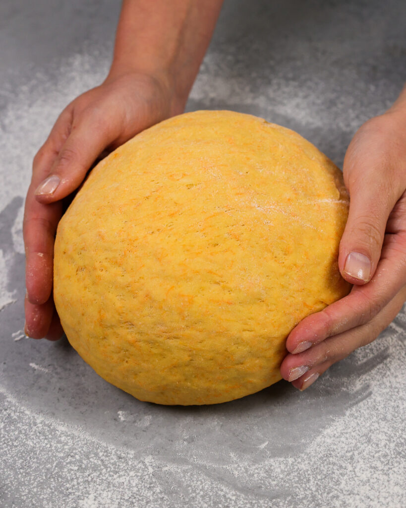 image of carrot cake cinnamon roll dough that's ready to be rolled out