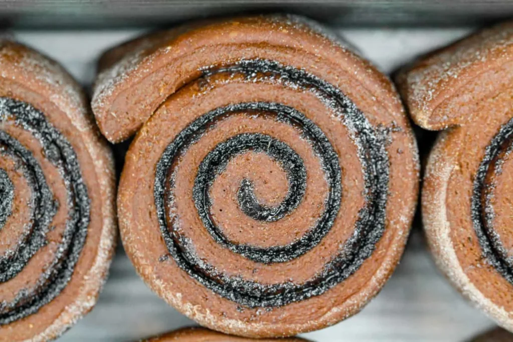 image of a chocolate cinnamon roll that is being shared as part of a cinnamon roll round up