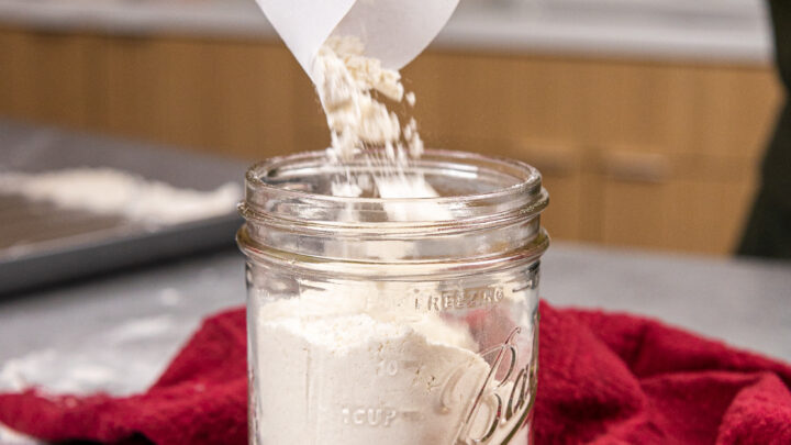 https://chelsweets.com/wp-content/uploads/2021/12/pouring-heat-treated-all-purpose-flour-into-an-airtight-jar-to-store-it-for-the-future-720x405.jpg