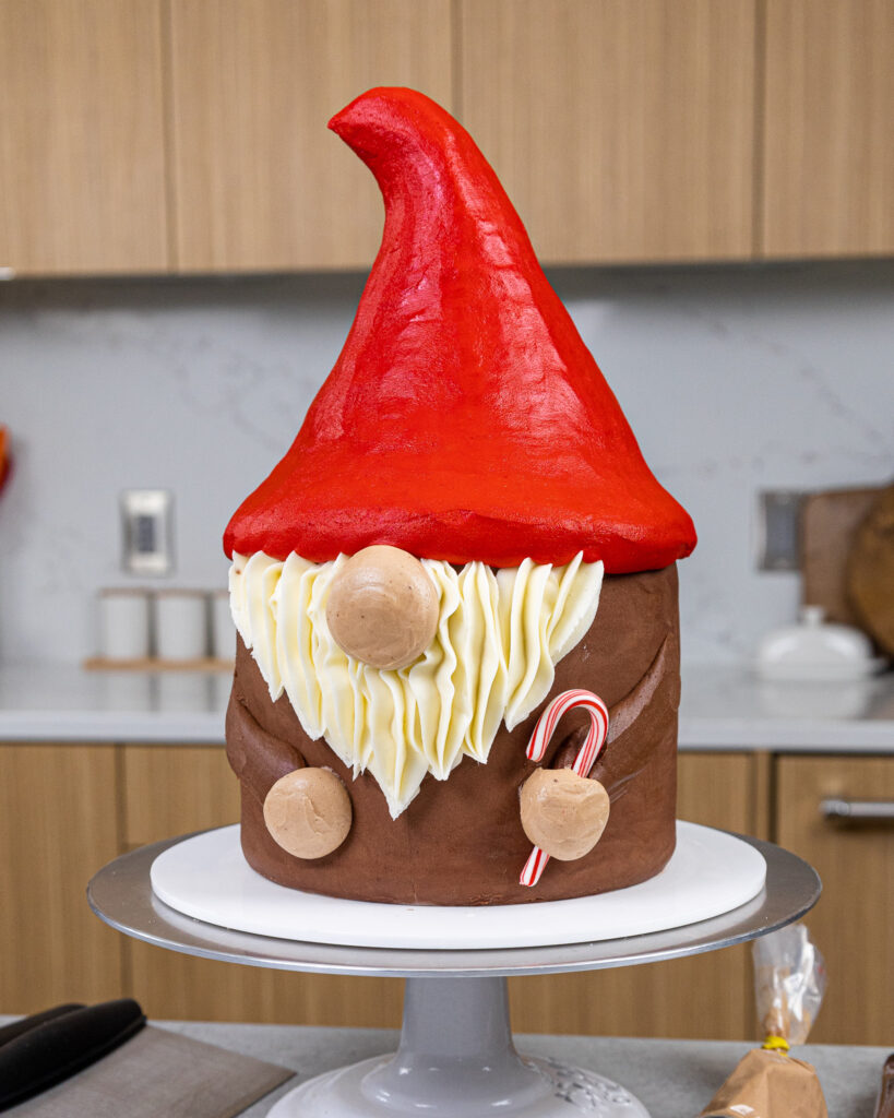 image of an adorable gnome cake that's been made with buttercream and rice krispie treats