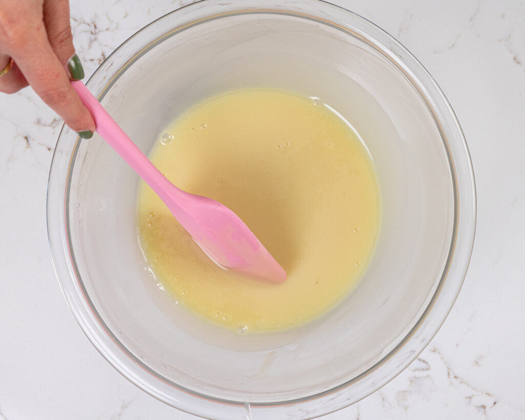 image of white chocolate and heavy cream being melted down together to make a thin ganache