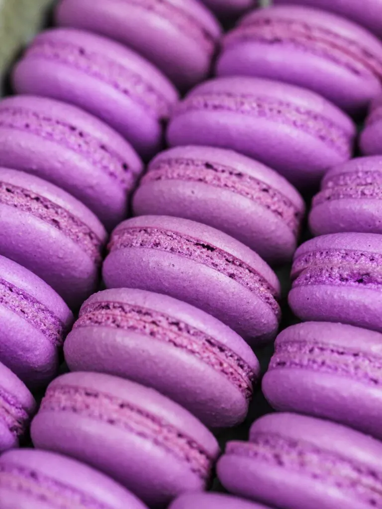 image of purple french macaron shells baked with perfect feet ready to be filled