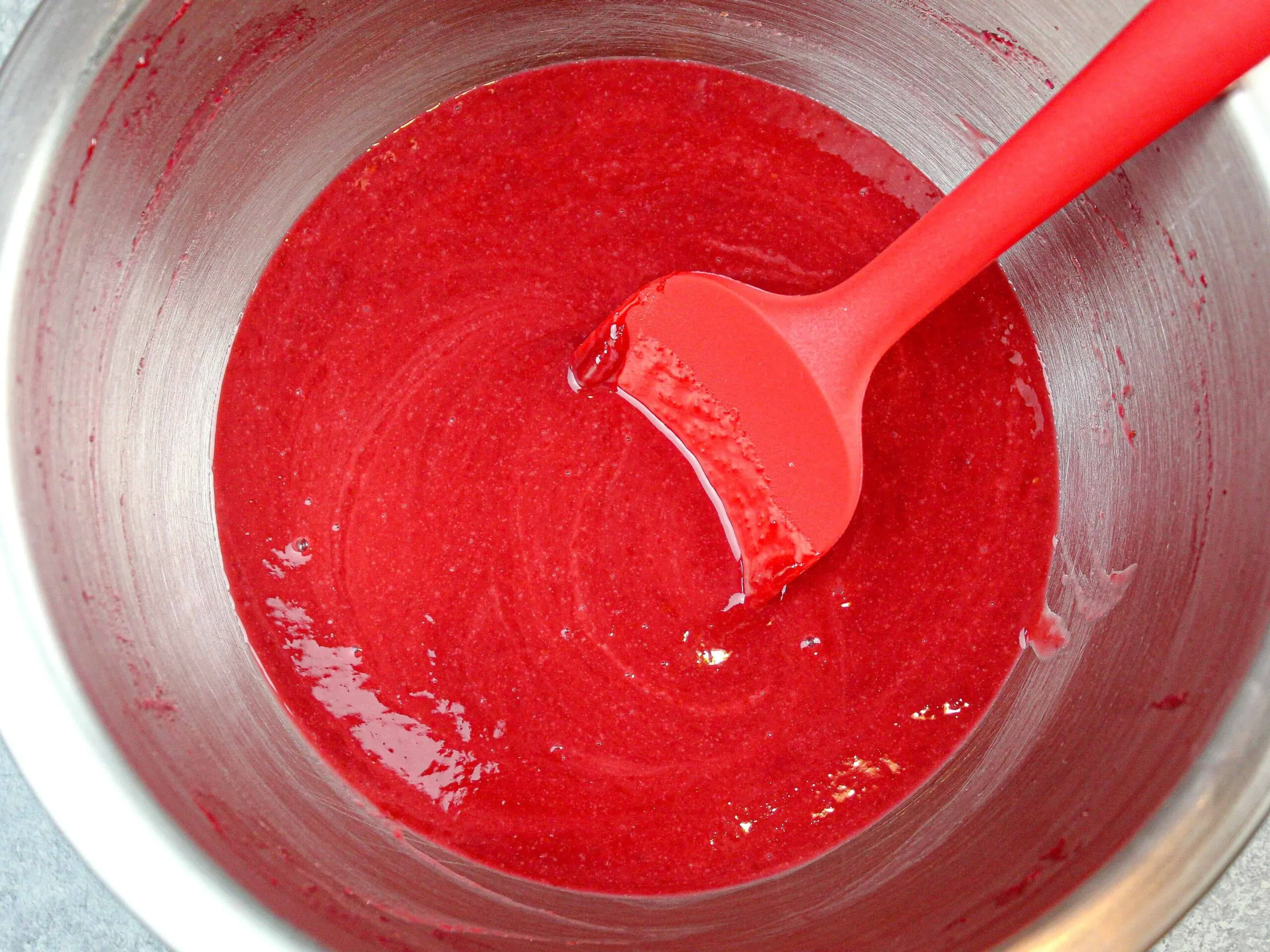 image of stained raspberry cake filling, before being thickened with cornstarch