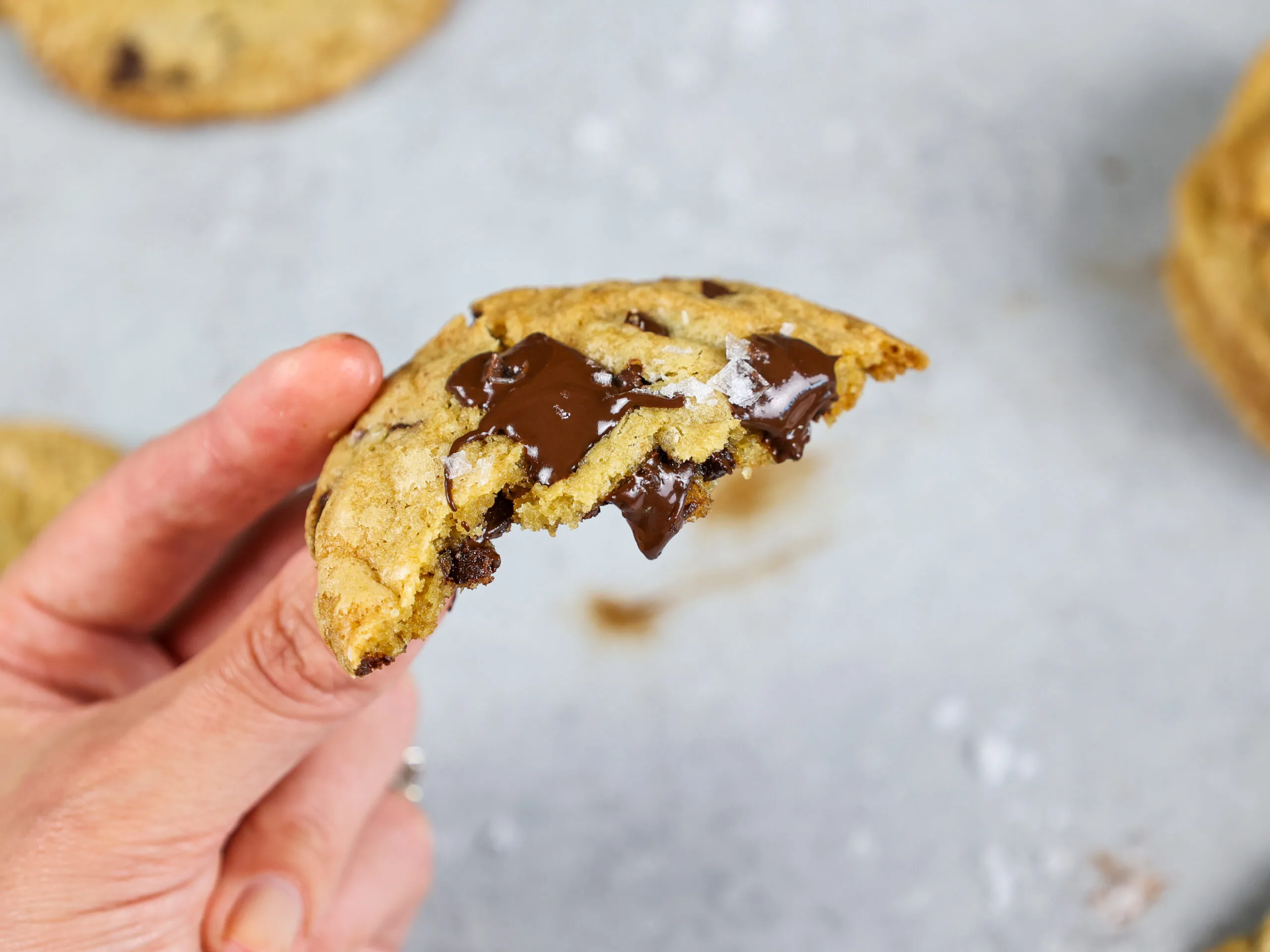 image of a no chill chocolate chip cookies that's been bitten into to show how chewy and soft it is
