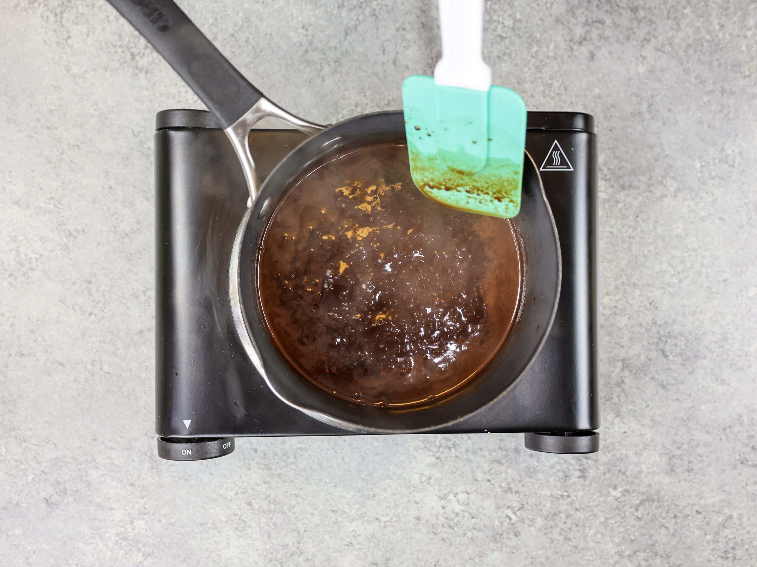 image of chocolate simple syrup being brought to a boil in a sauce pan.