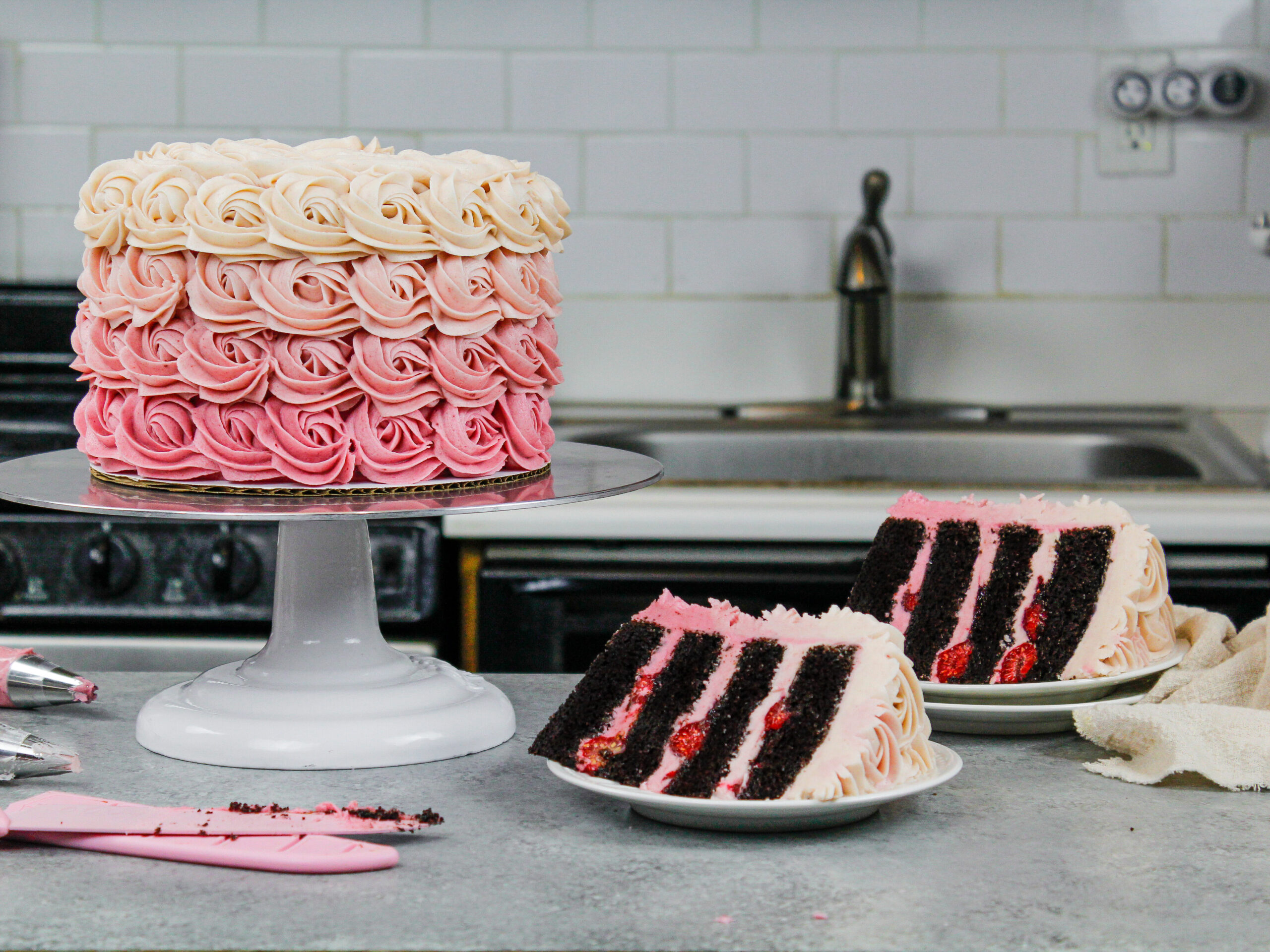 image of a chocolate raspberry cake that's been decorated with ombre buttercream rosettes