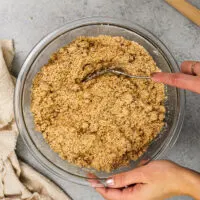 image of cinnamon streusel topping being mixed in a class bowl
