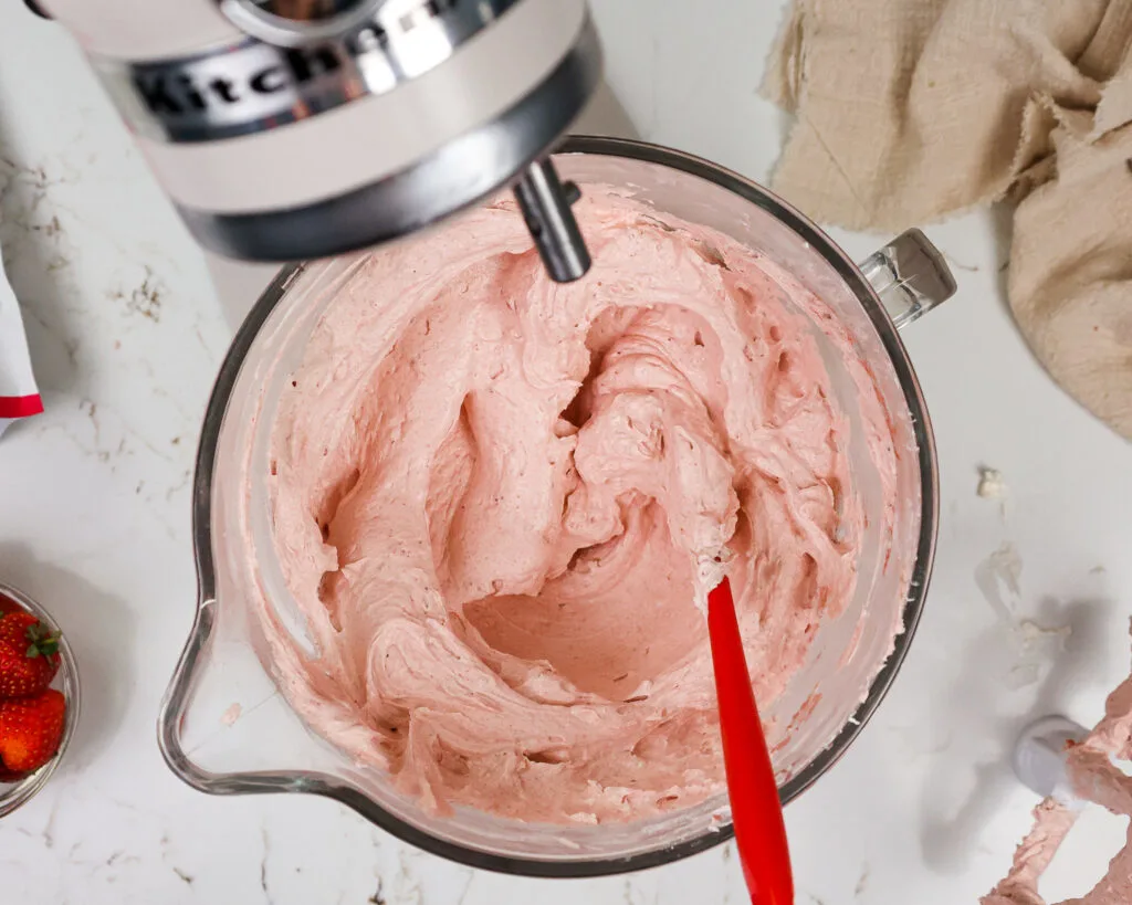 image of strawberry swiss meringue buttercream that's been mixed and ready to be used