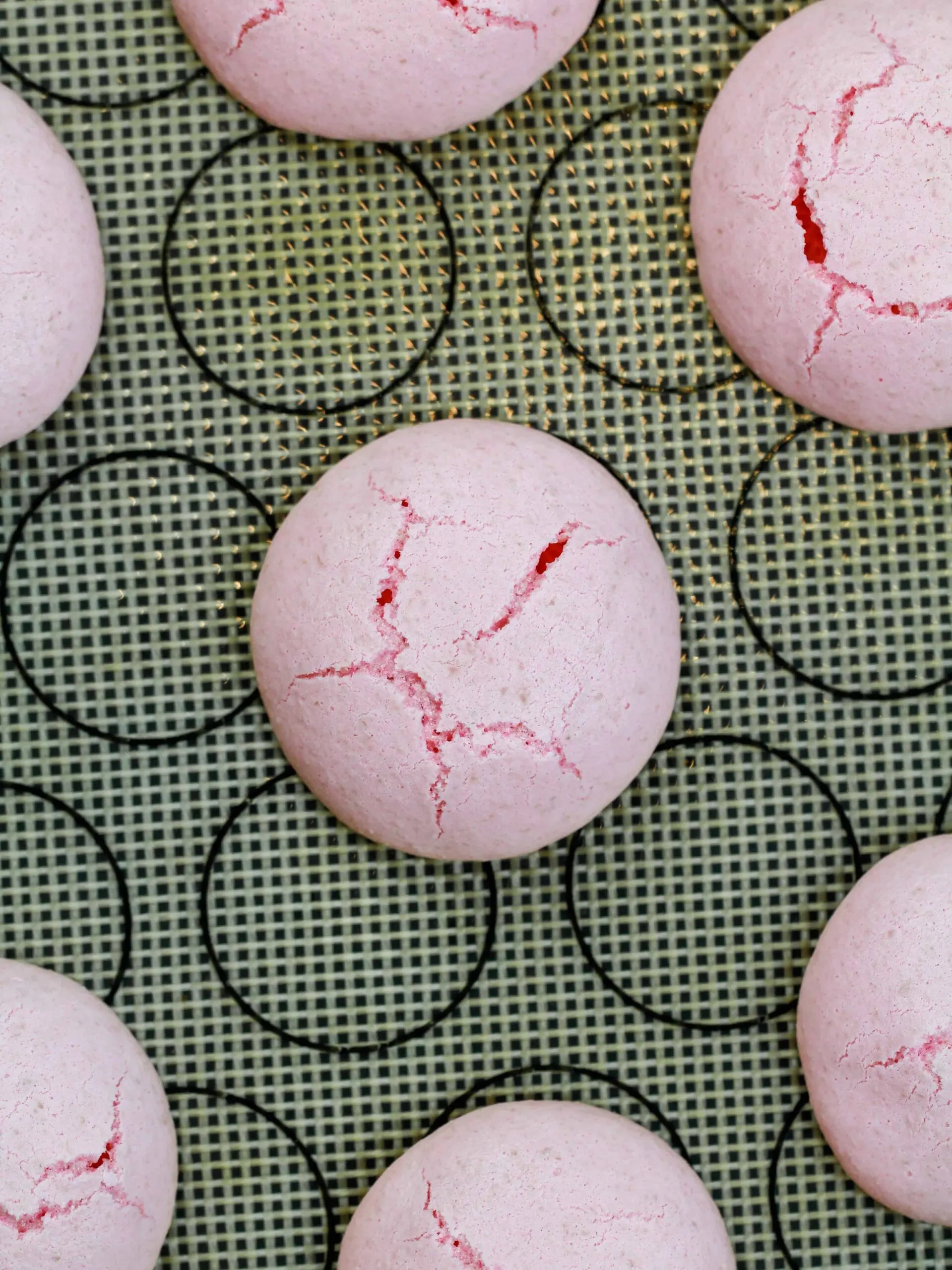 image of cracked italian macarons that were baked in too hot of an oven