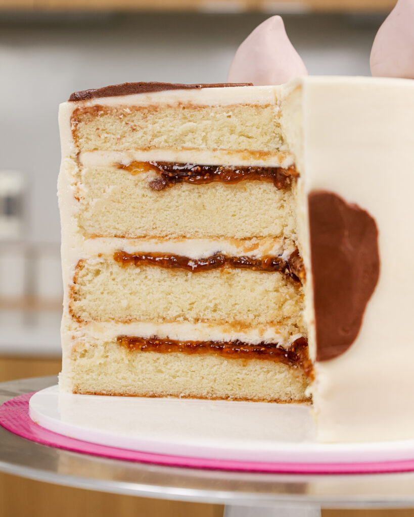 image of a cross section of a goat cake that's filled with goat cheese frosting and fig jam
