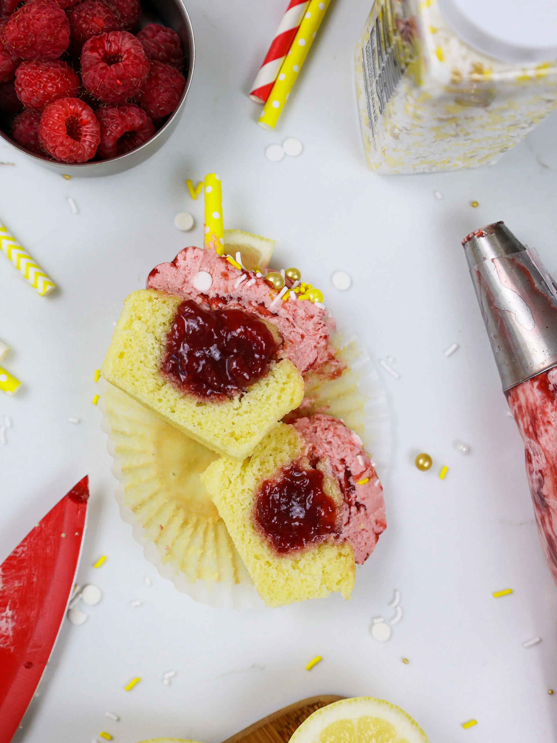 image of a raspberry lemonade cupcake cut open to show it's raspberry filling