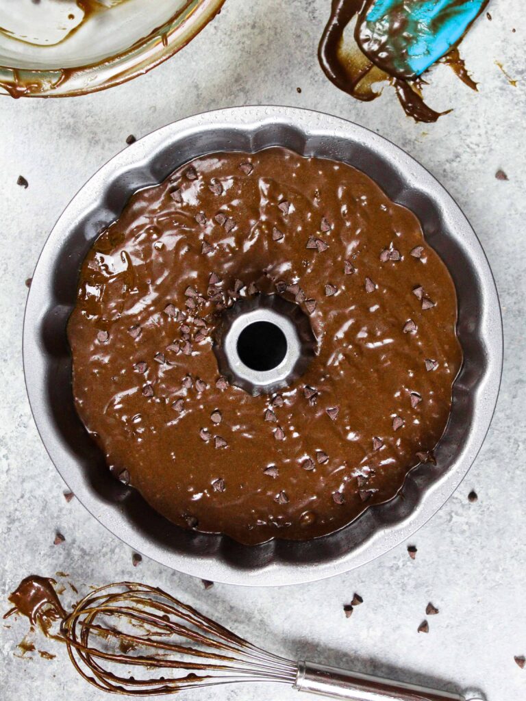 image of chocolate pound cake batter that's been poured into a classic bundt cake pan
